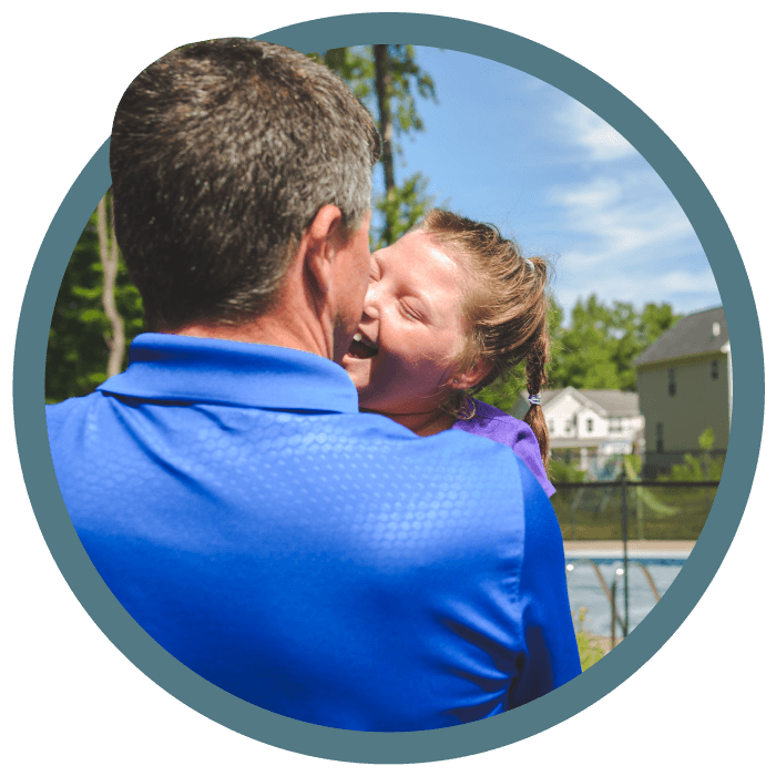 A man picking up his daughter