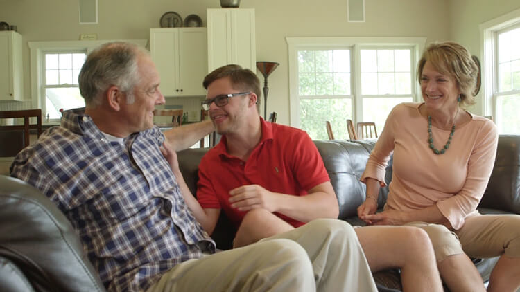 A family sitting on a couch