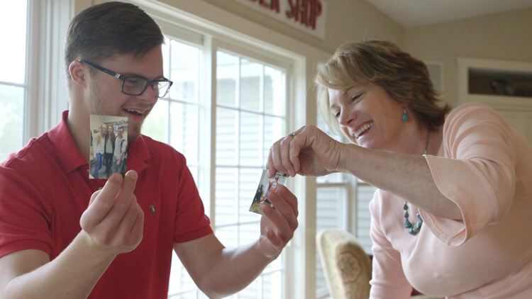 A mother and her son laughing and looking at pictures