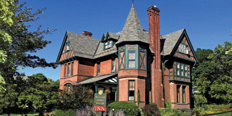 The brick and shingle exterior of the William Henry Miller Inn as shown on a clear sunny day.